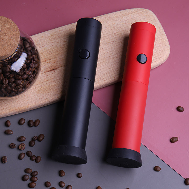 Red handheld electric milk frother with storage cap