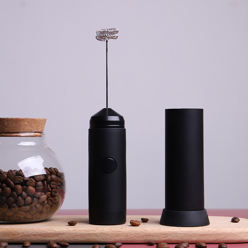 Black handheld electric milk frother with storage cap